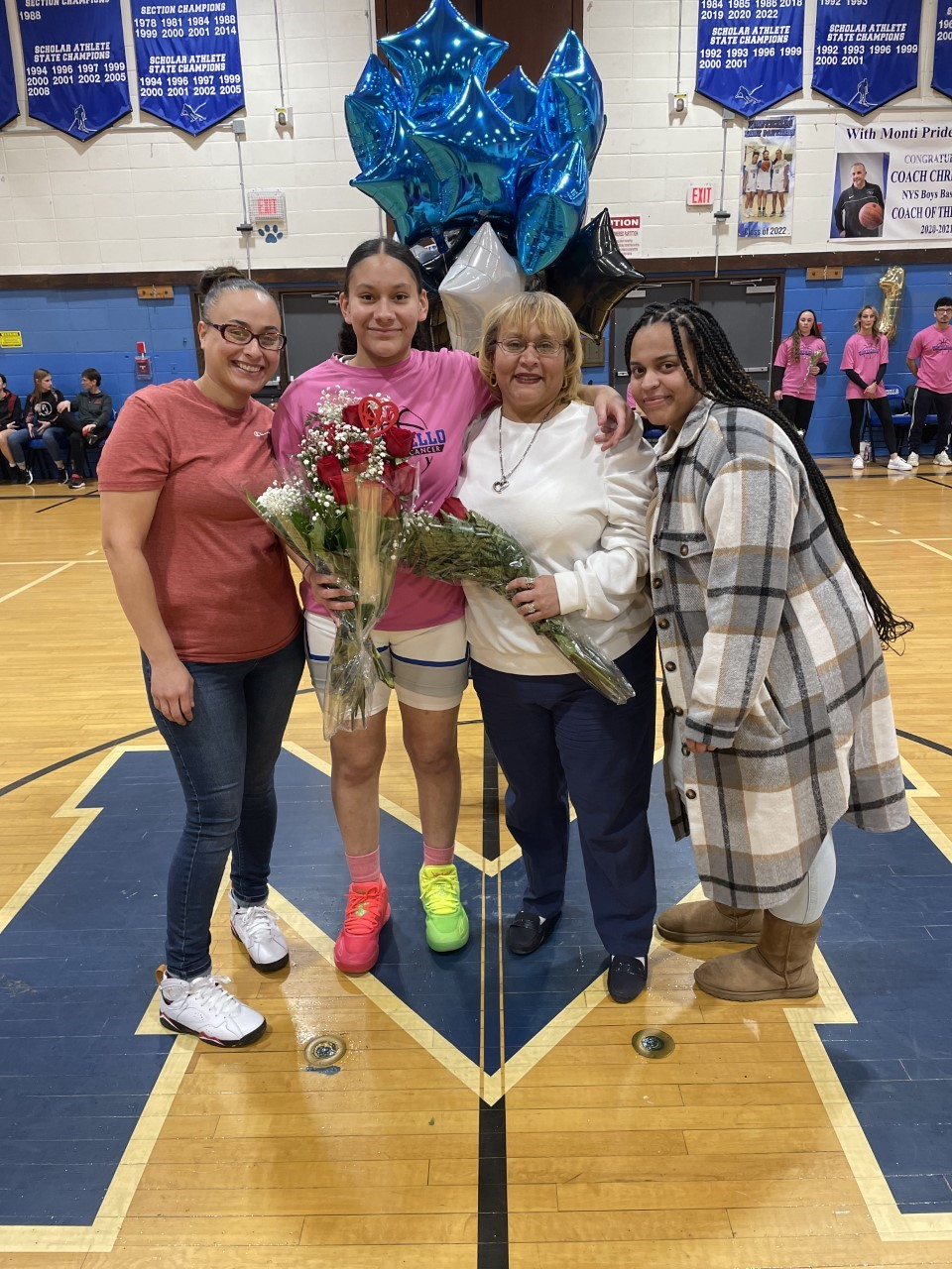 senior athletes pose with their family