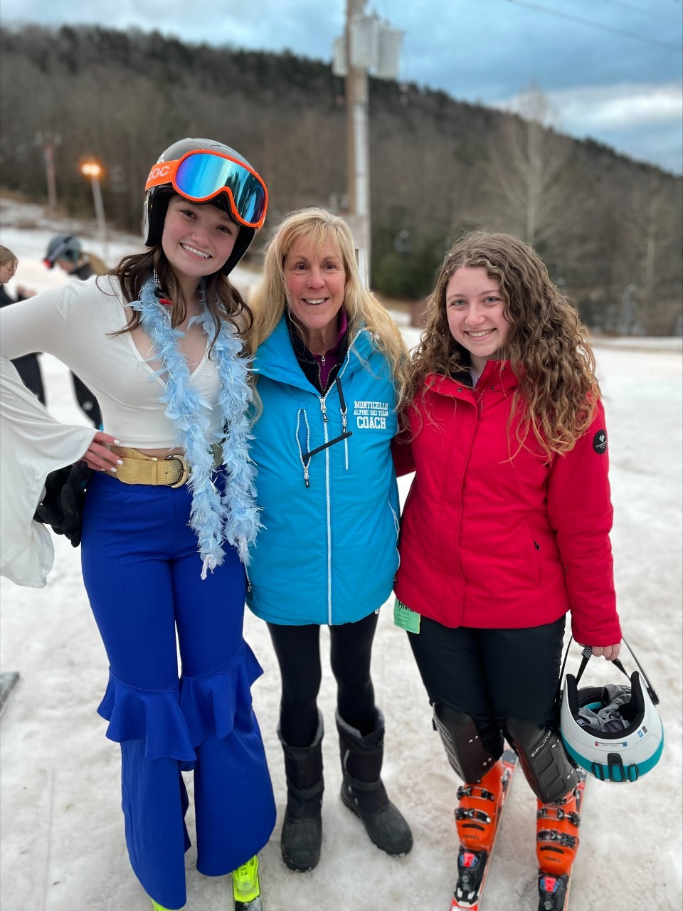 skiers are posing with coach