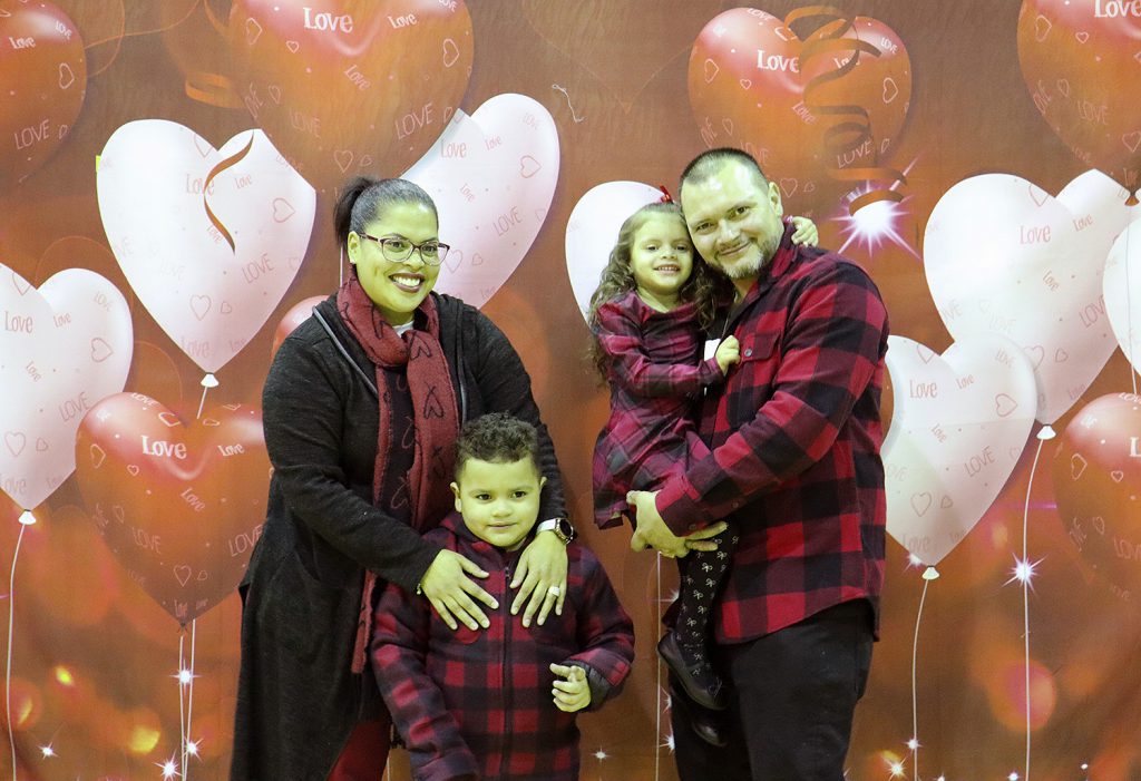 Family smiling for a photo together.