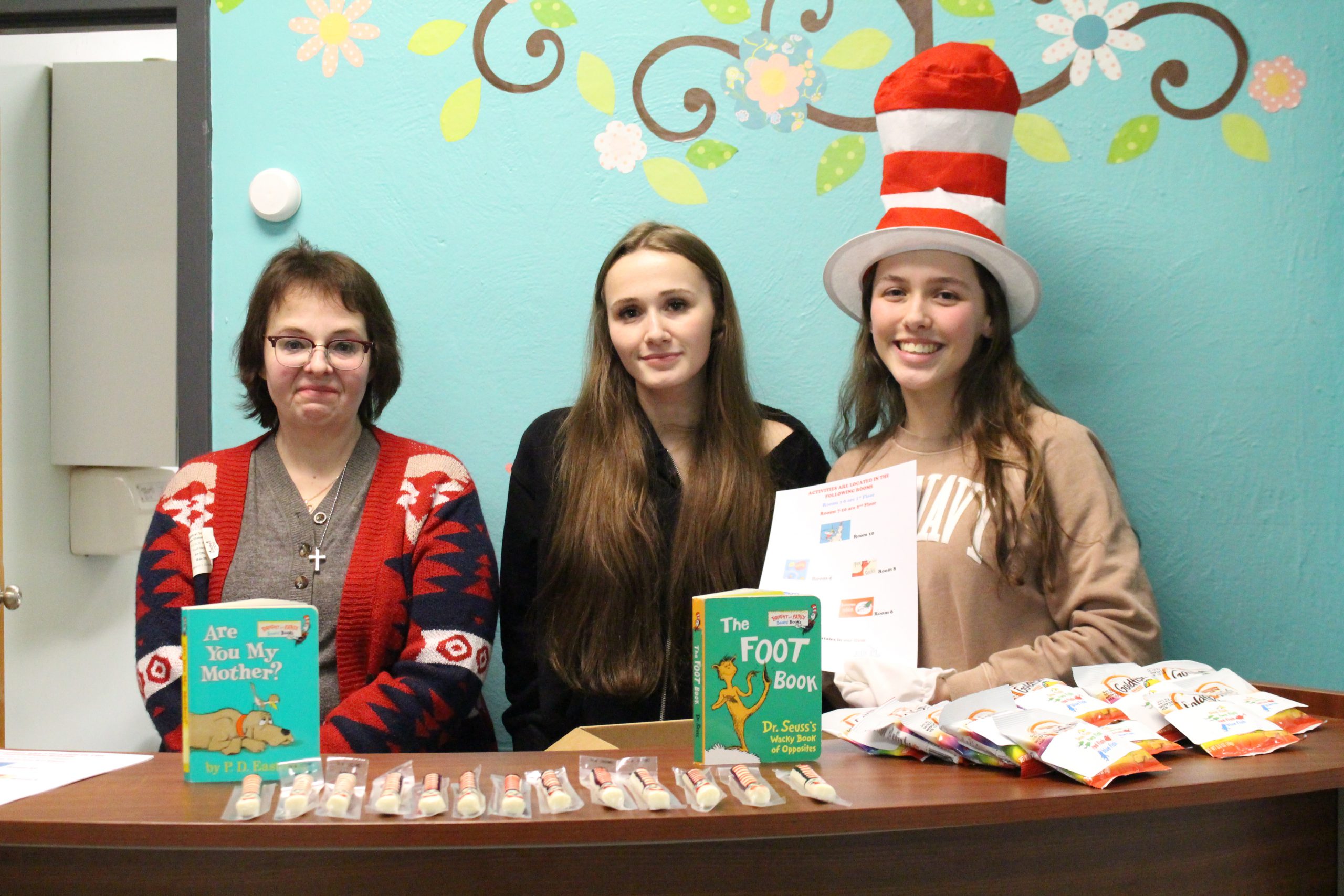 students are posing by a front desk