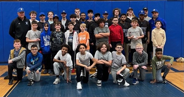 a group of teen baseball athletes are posing.