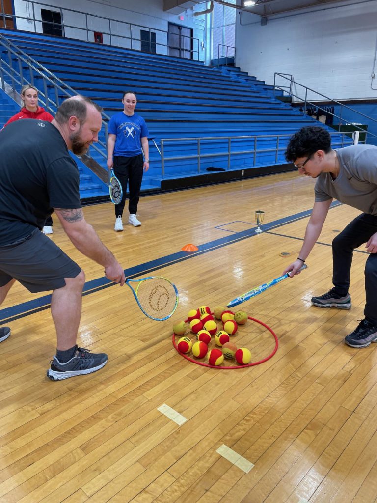 two teachers are participating a tennis clinic