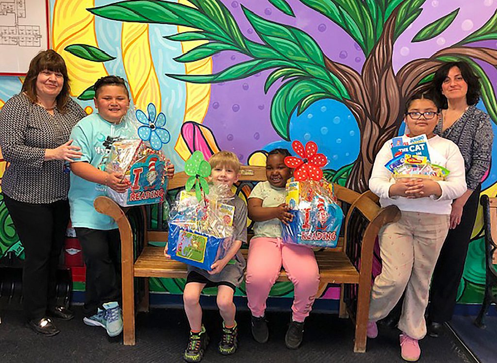 Group of students holding their baskets with two teachers.