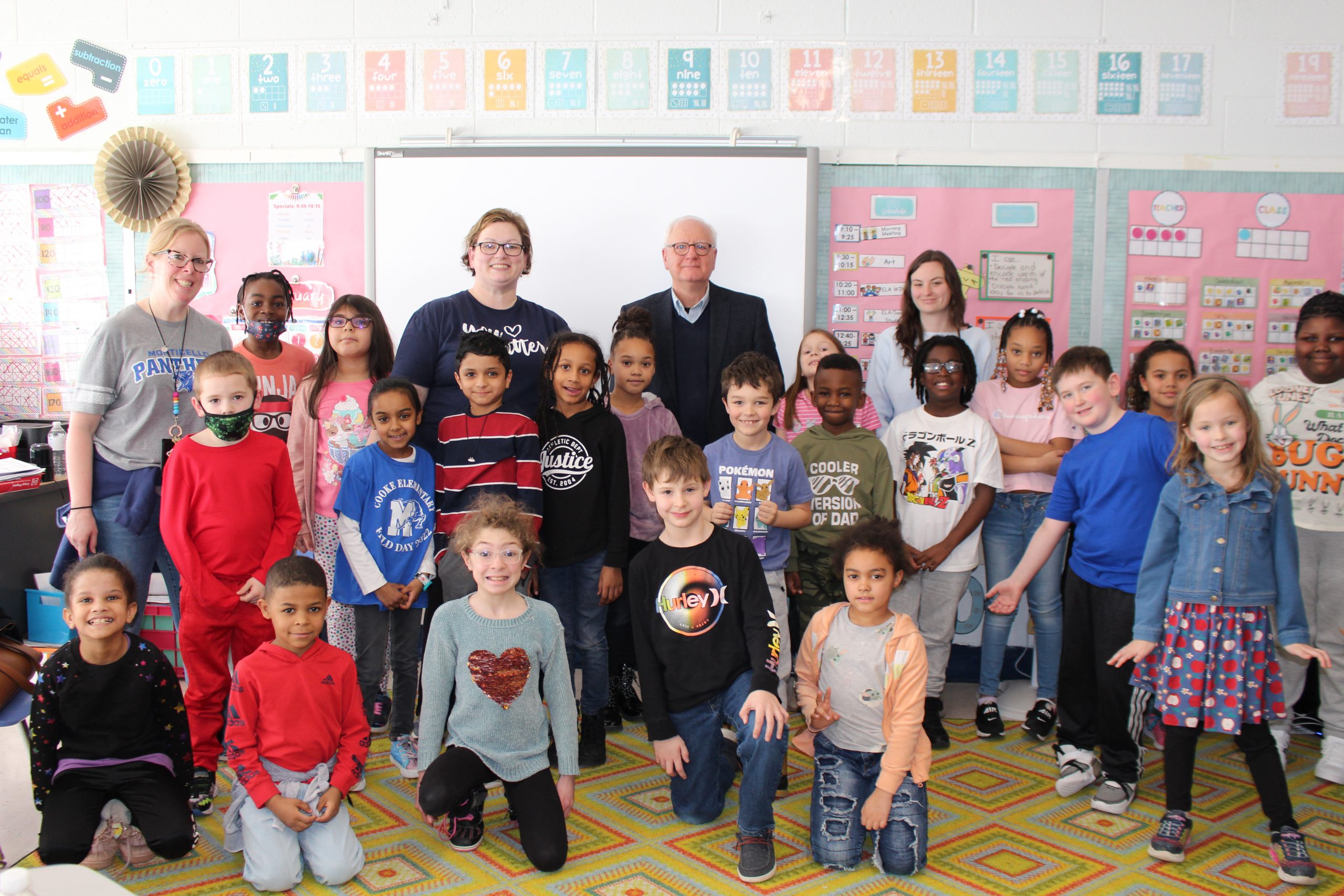 a group of students is posing at the front of the class with Mr. Conway