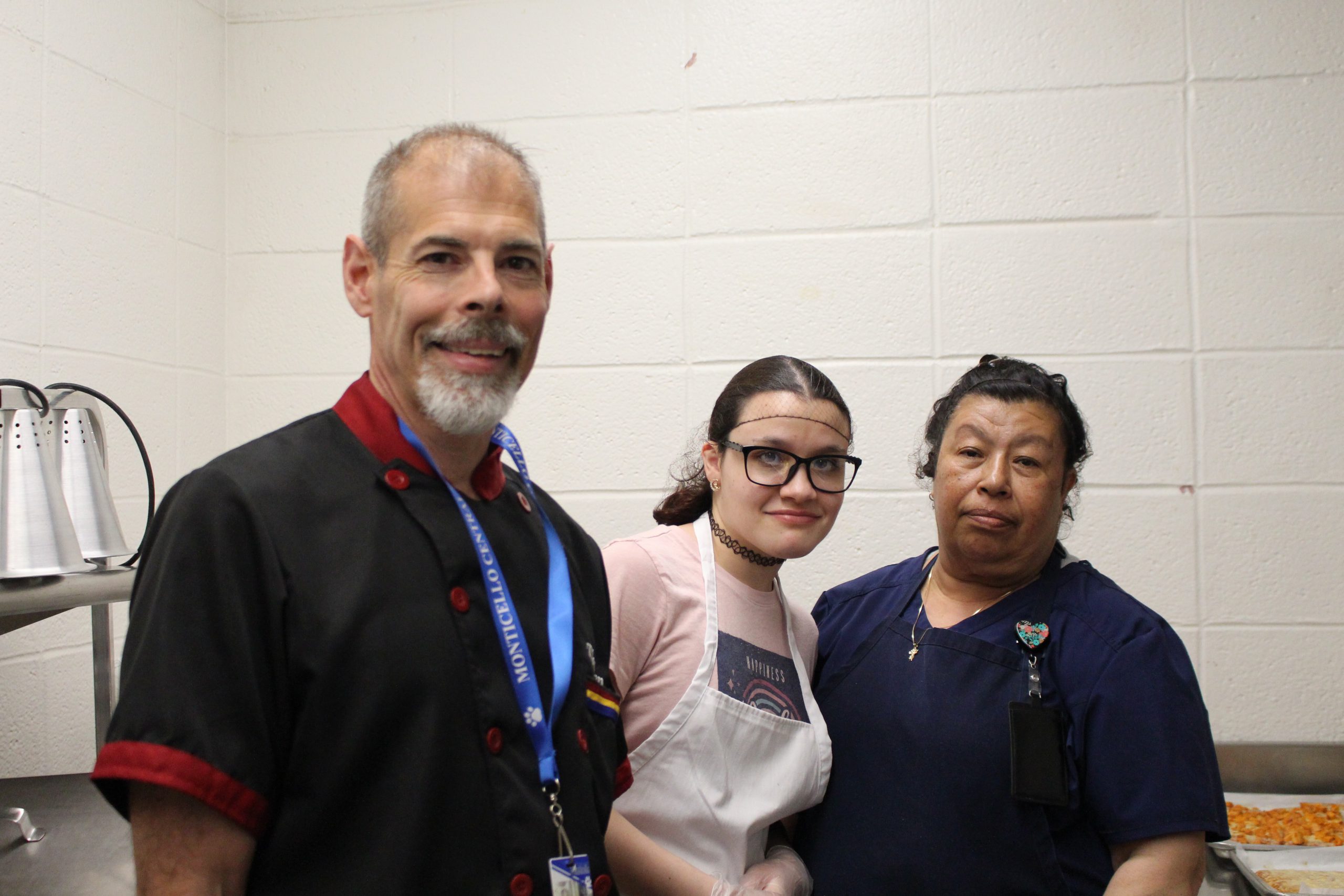 Mr. Thurston poses with high school food service staff members 