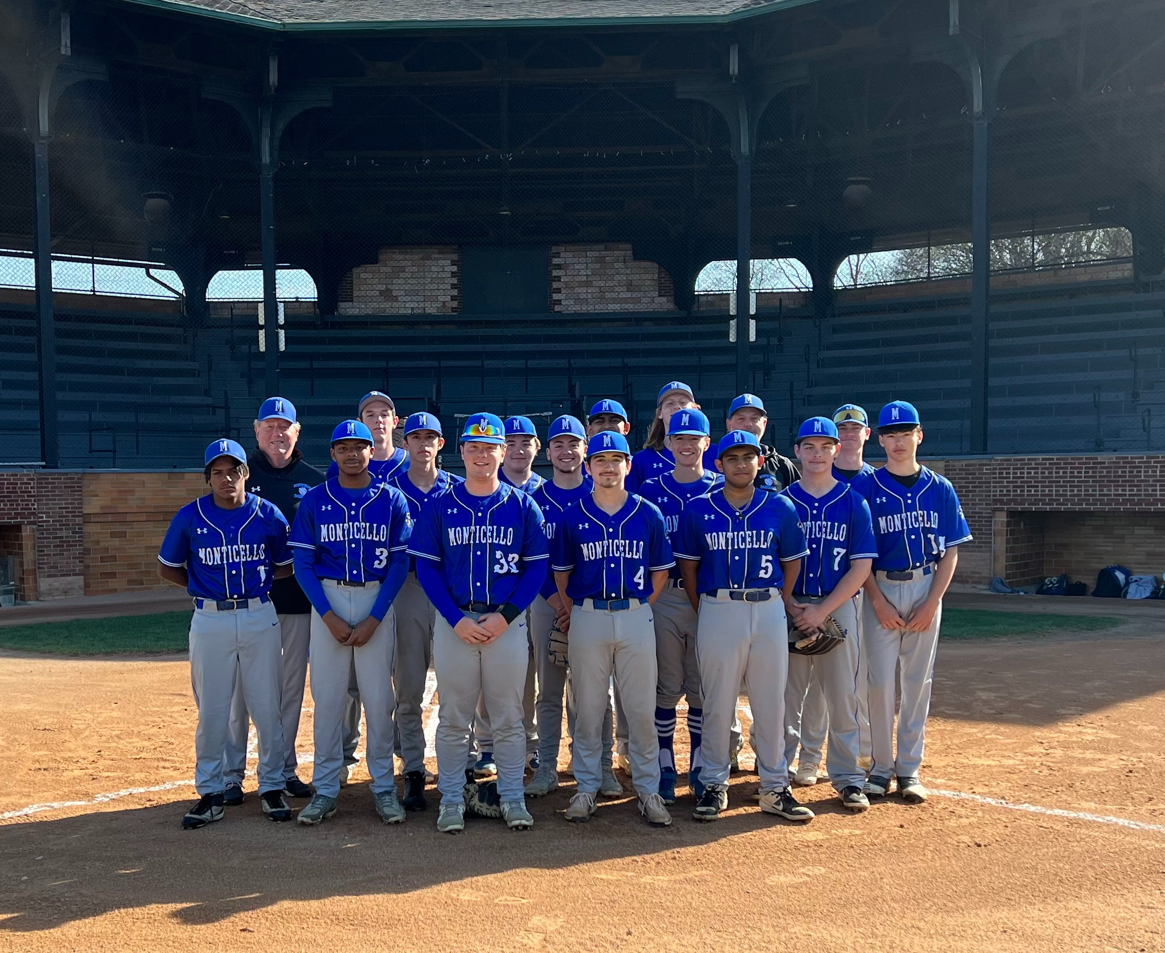 the baseball team is posing on a field 