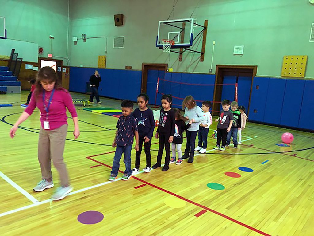 Physical therapist showing students how to move.