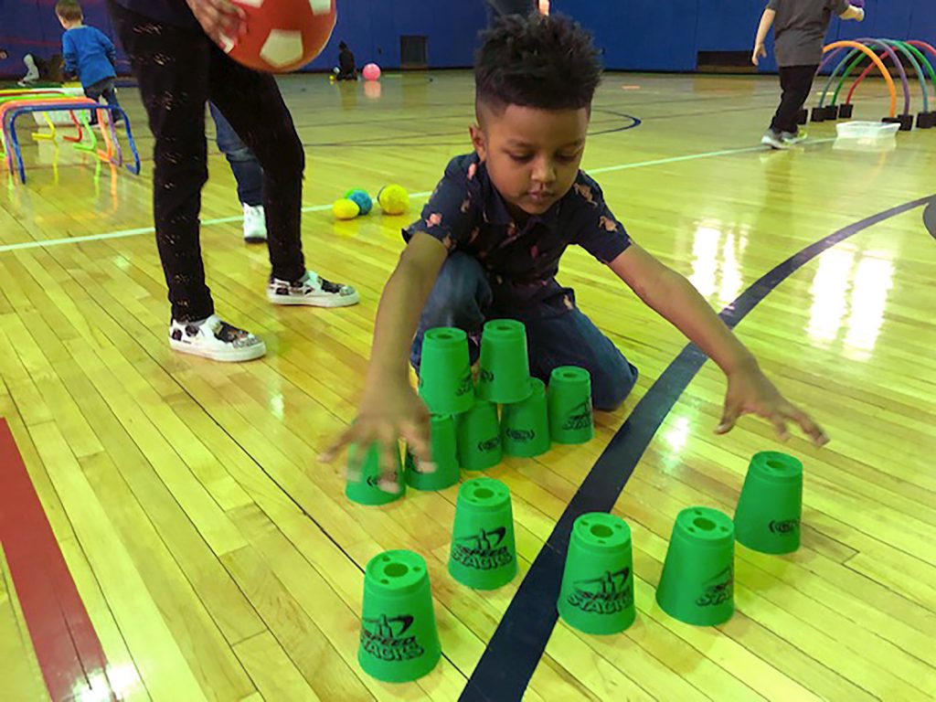 Student building a tower out of cups.