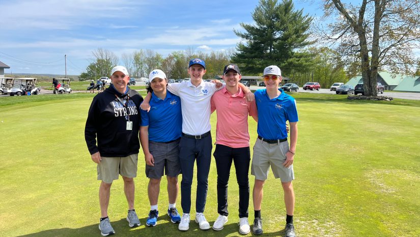 the boys golf team is posing