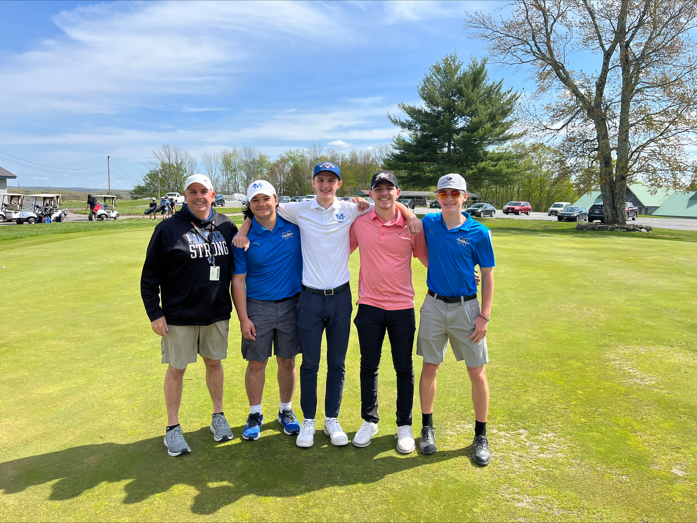 the boys golf team is posing 