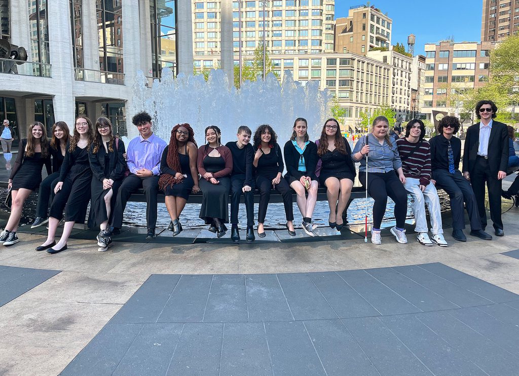 Students sitting at a water fountain.