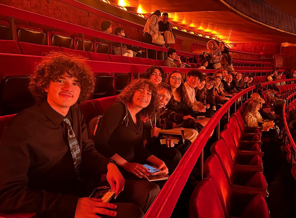 Students sitting in a theatre. 