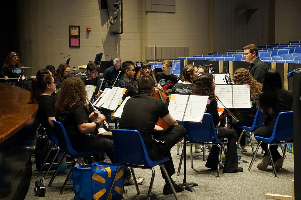 Student musicians playing instruments. 