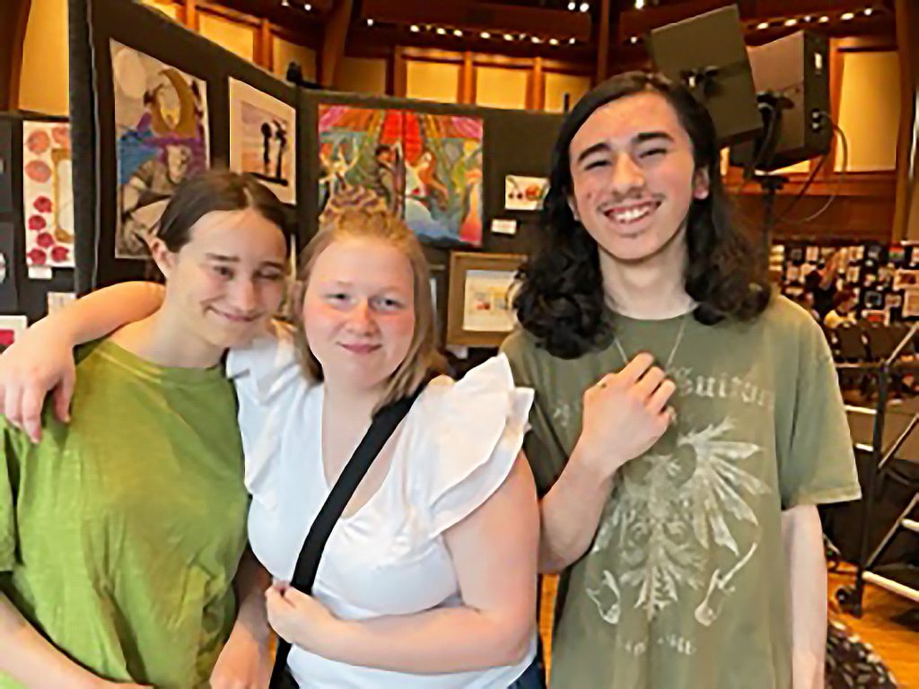 Three students smiling.