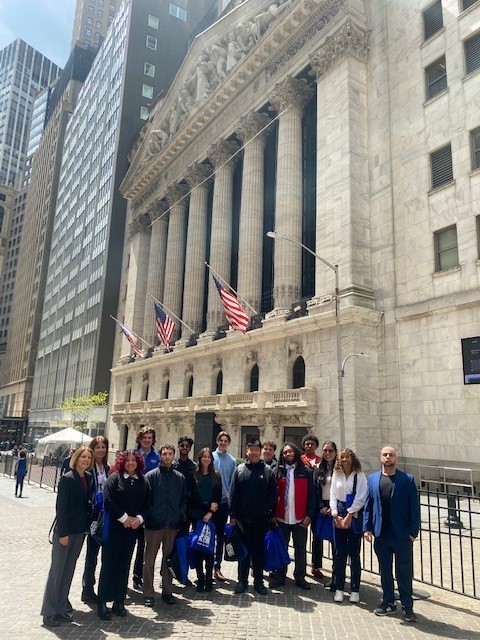 A group of students are posing in front of a building 