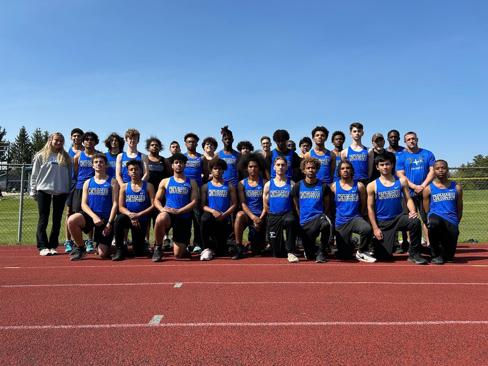 the boys track team is posing 