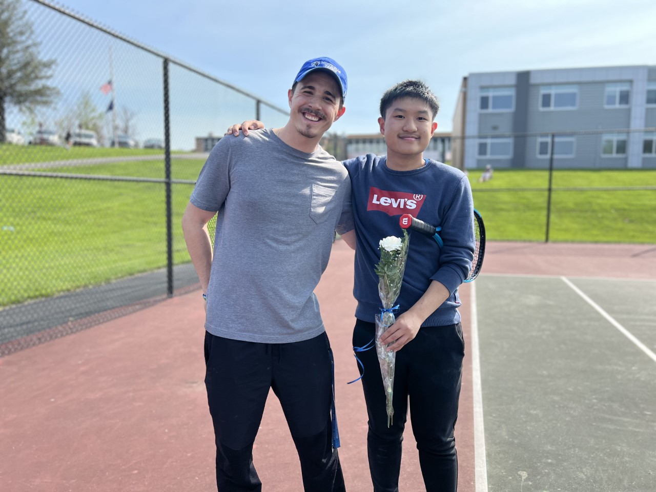Eddie Chen is posing with his coach