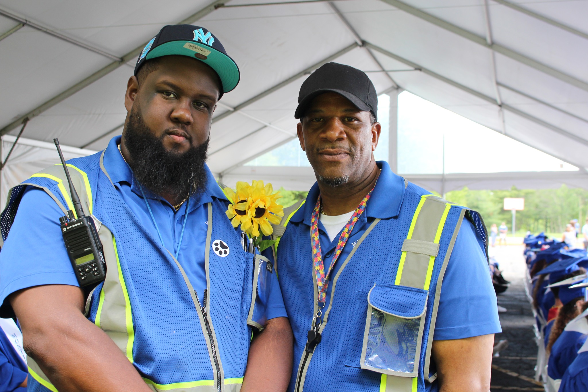 A Monticello security attendant is holding a coffee cup and smiling at the camera for a photo.