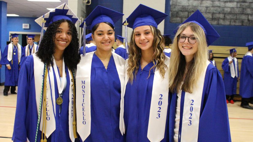 a group of female students in caps and gowns are posing