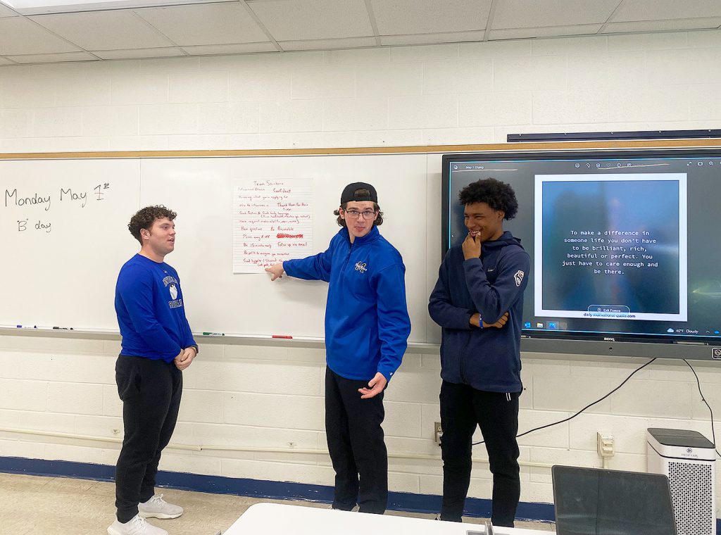 Student pointing at the white board.