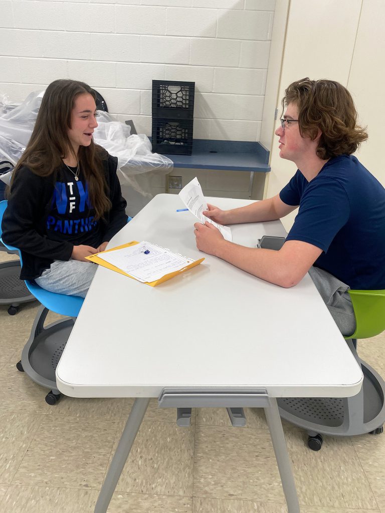 Two students interviewing each other.