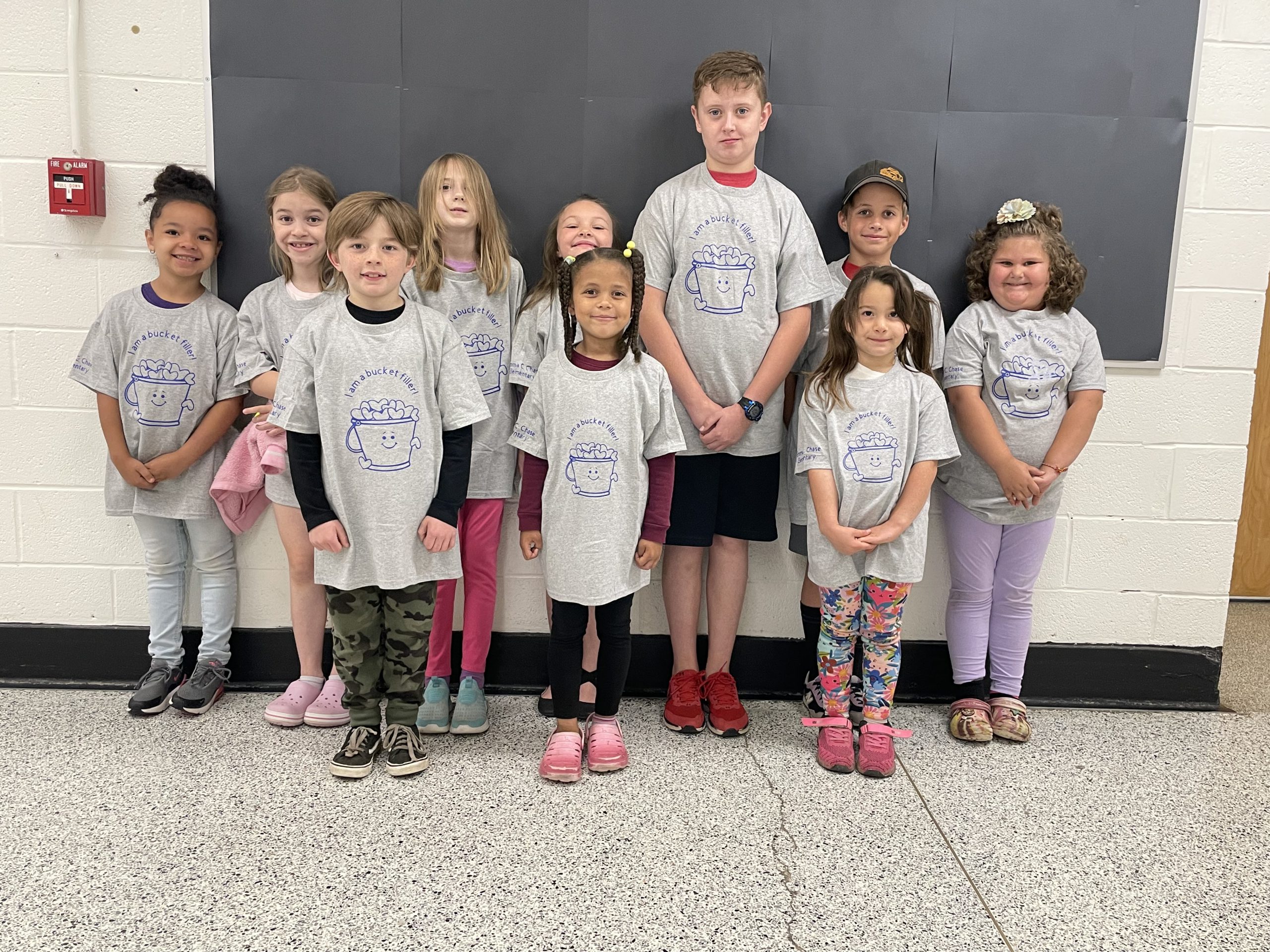 A group of students is wearing Bucket Filler tshirts 