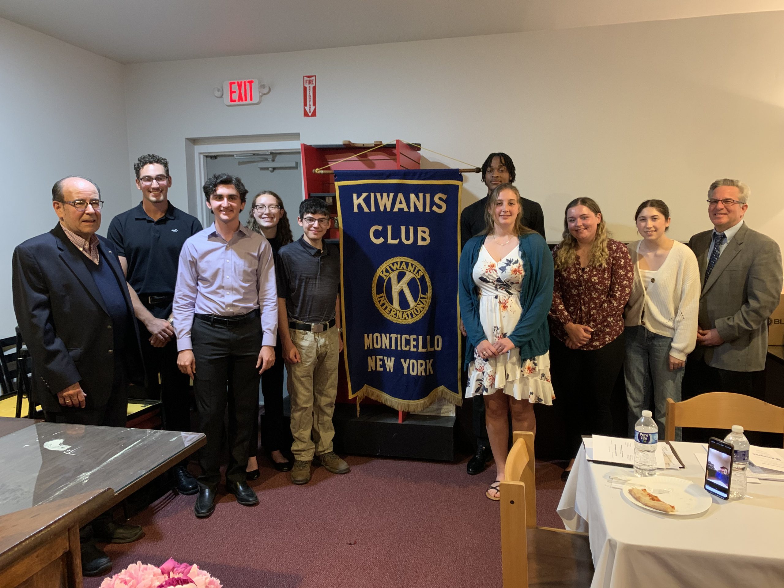 a group of students are posing with members of the Kiwanis 
