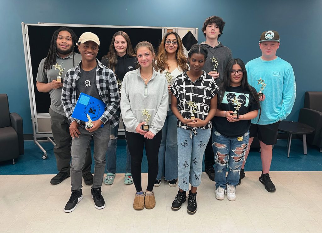 Students smiling together for a group photo.