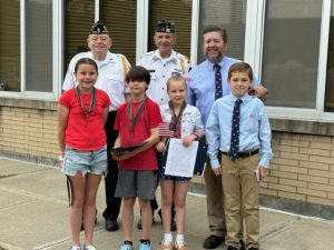 the three winners pose with members of the American Legion 