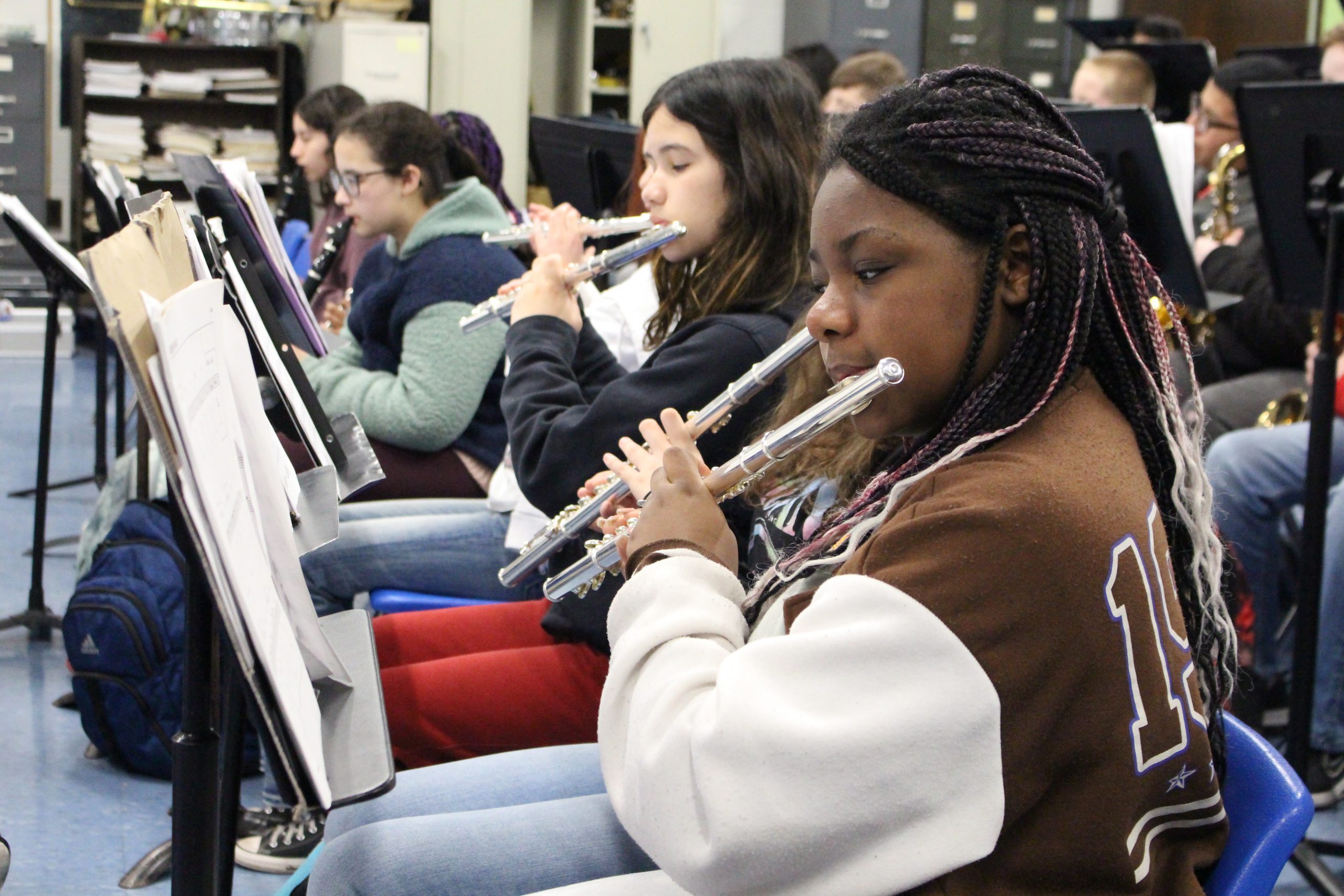 a female student is playing the flute 