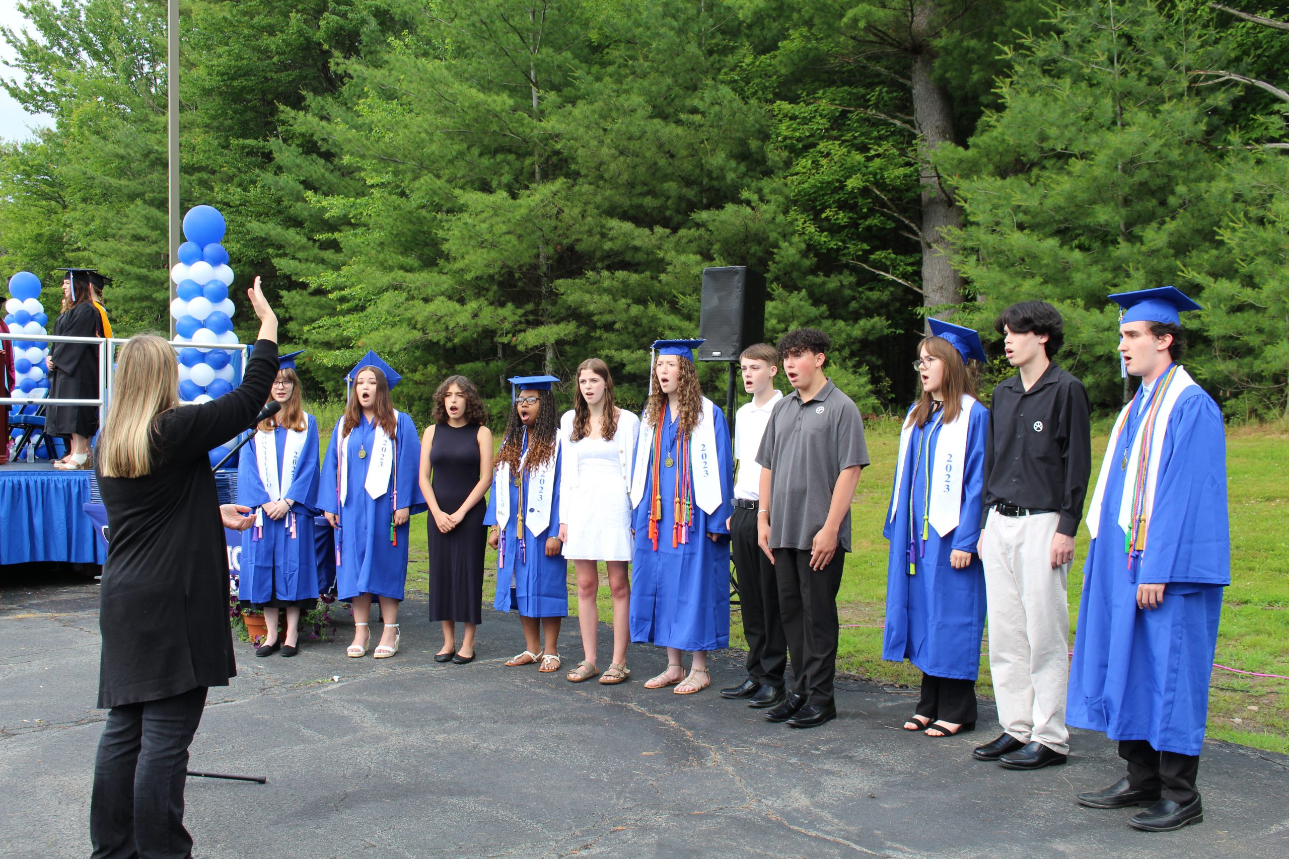 a group of students are singing 