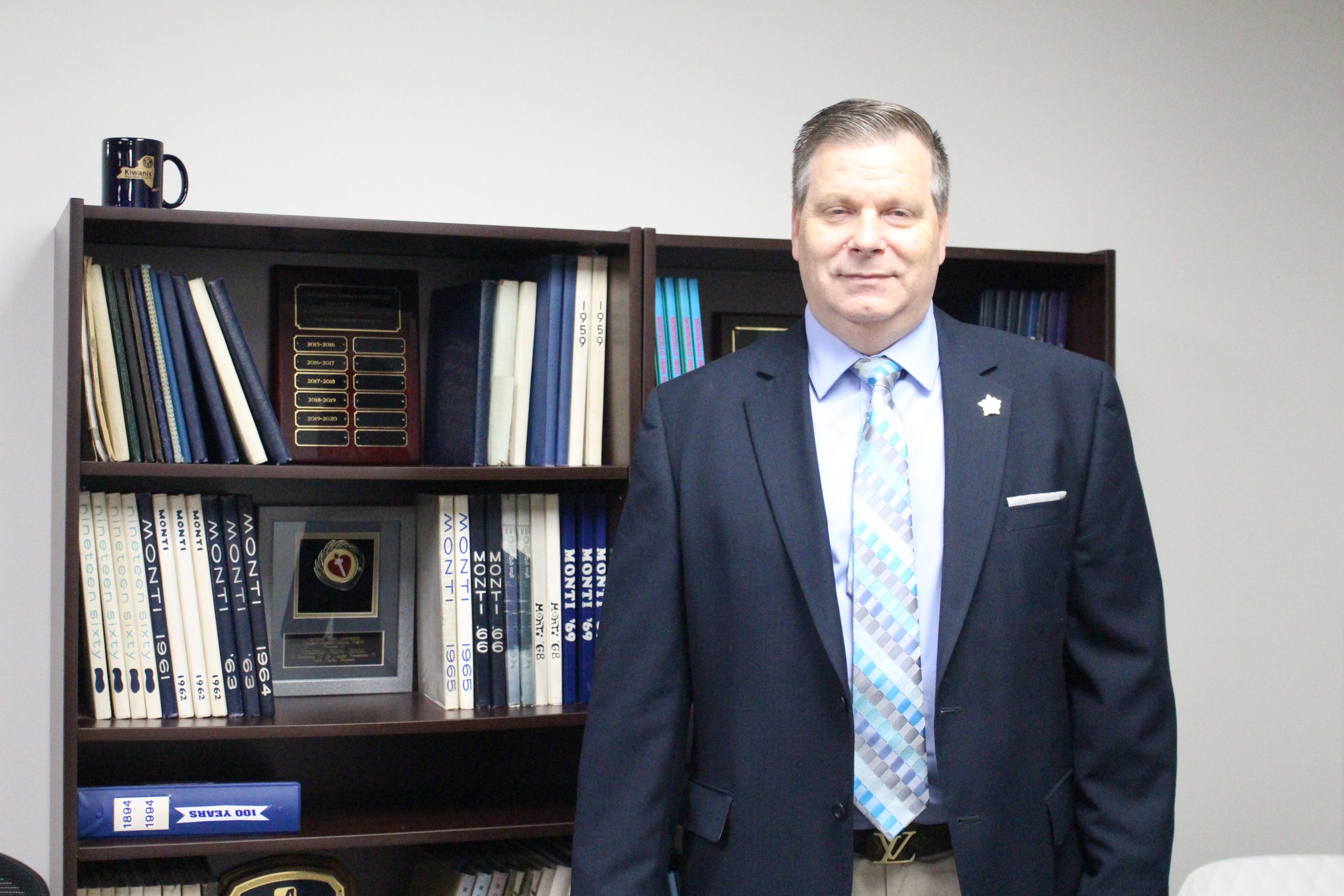 Dr. Gary Furman poses in front of a bookshelf