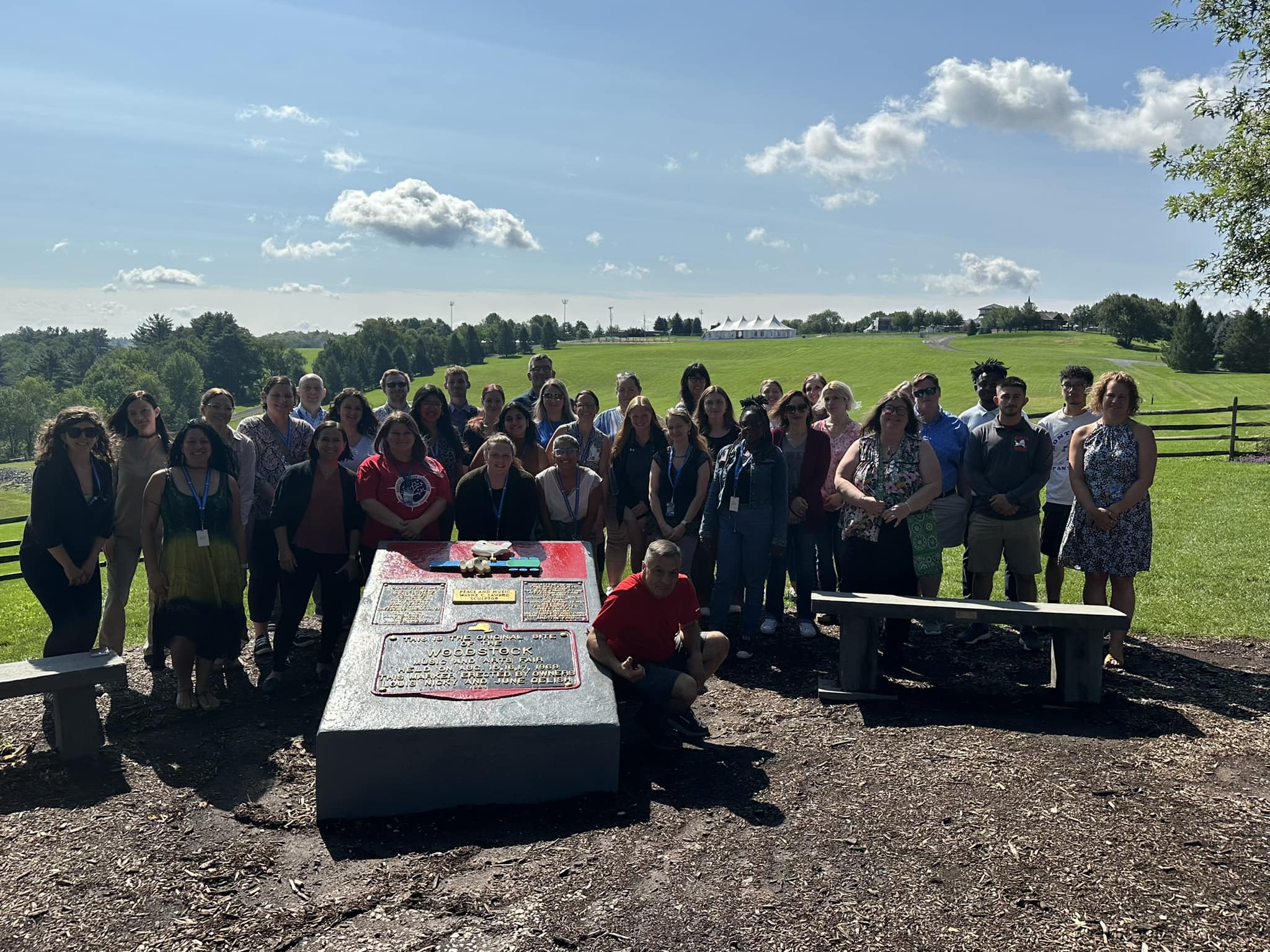 a group of t3eachers are posing in front of Bethel Woods