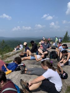 students sit on top of a mountain 