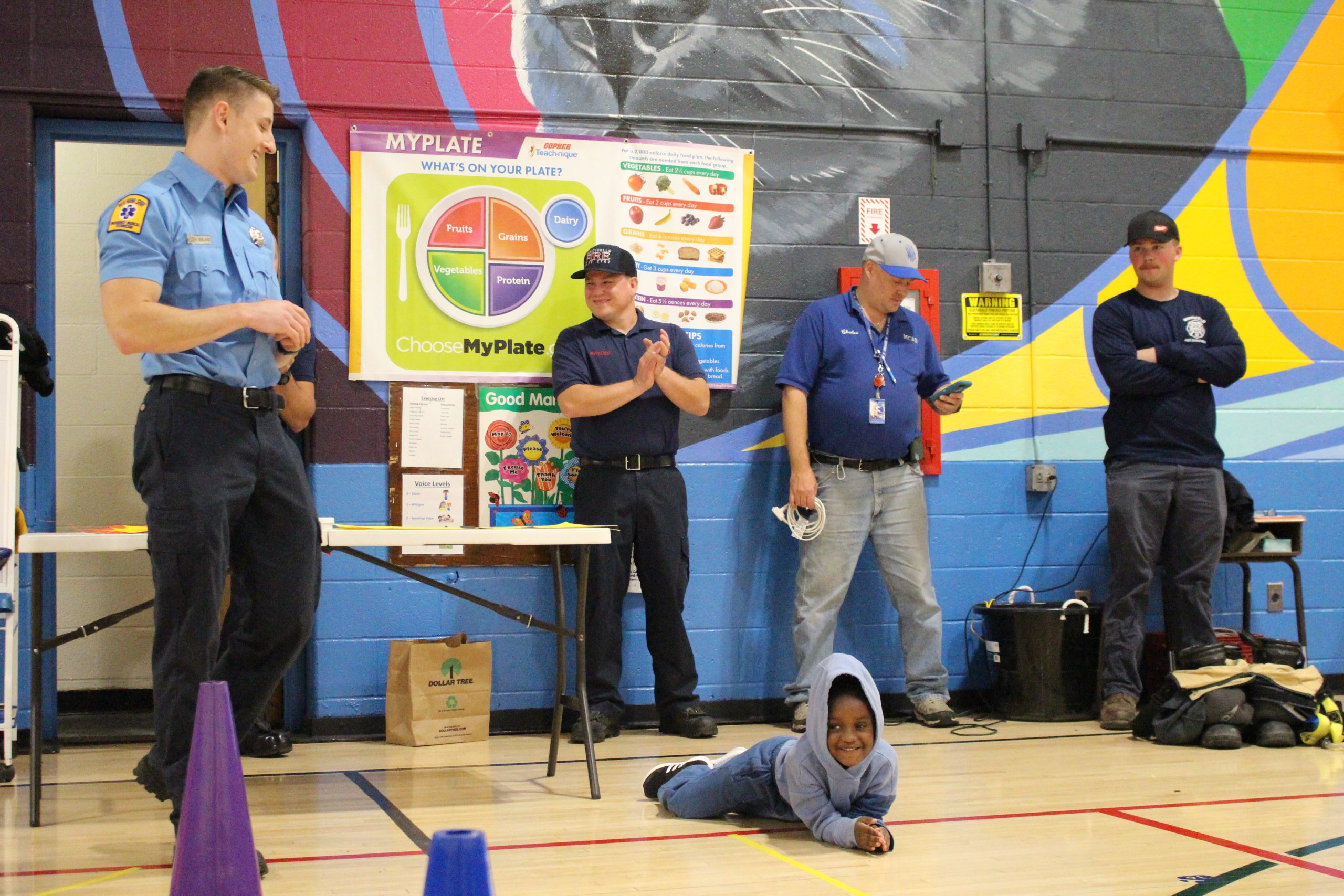 a student is demonstrating how to stop drop and roll 