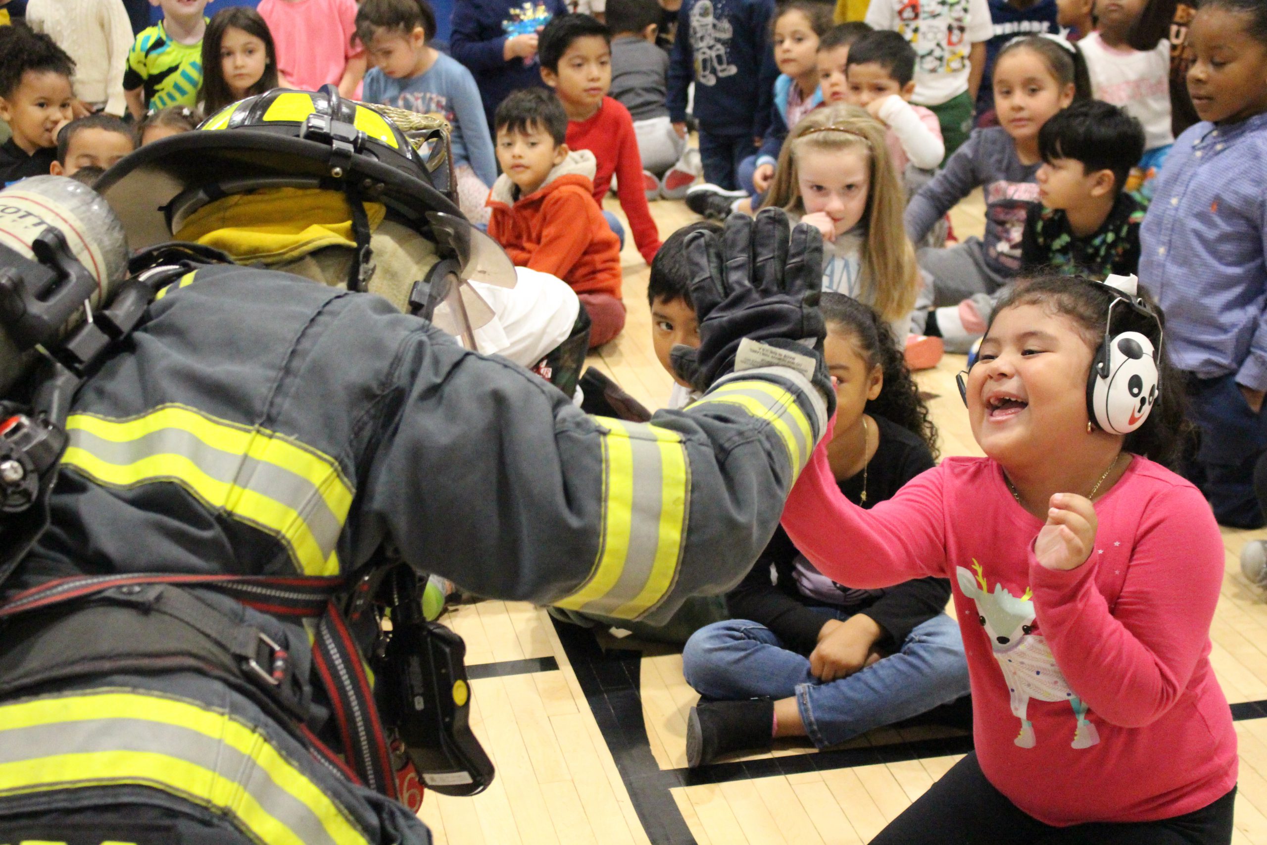 a student is "high fiving" a firefighter