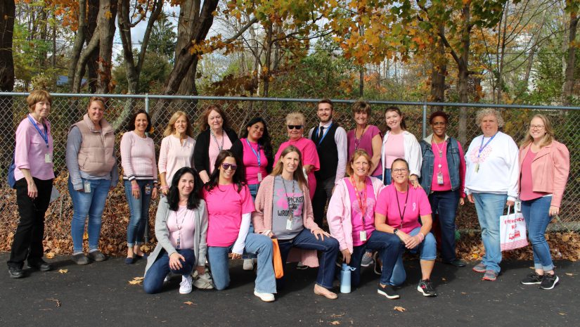 a group of teachers are wearing pink and denim