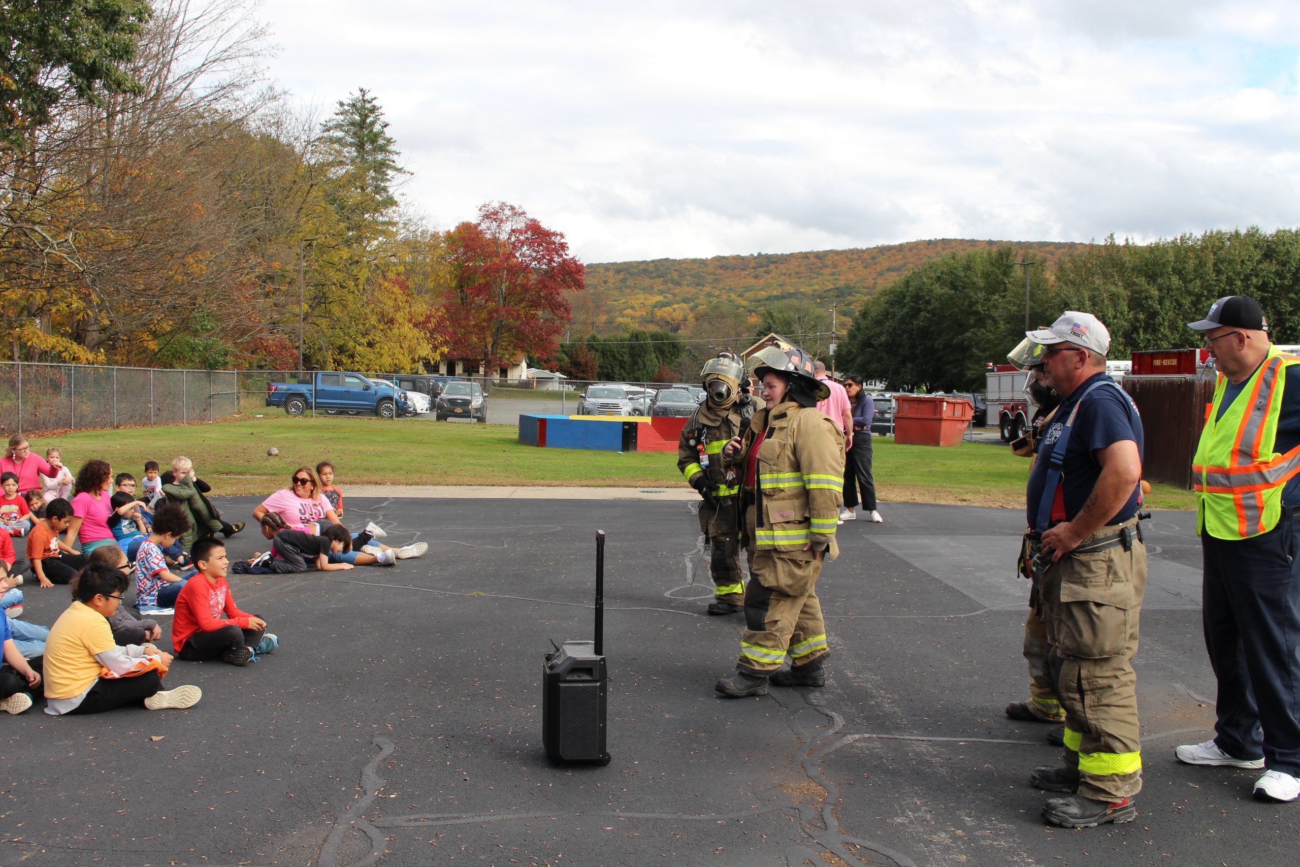 a group of firefighters is addressing students 