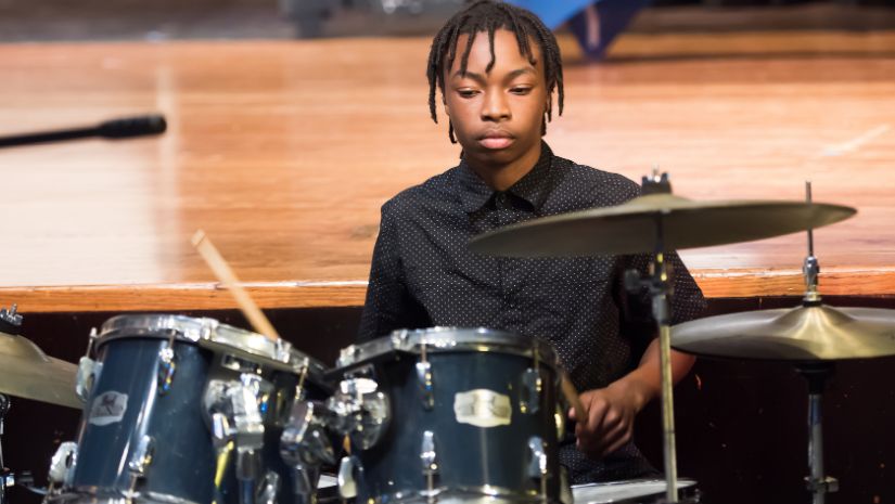 Student playing drums.