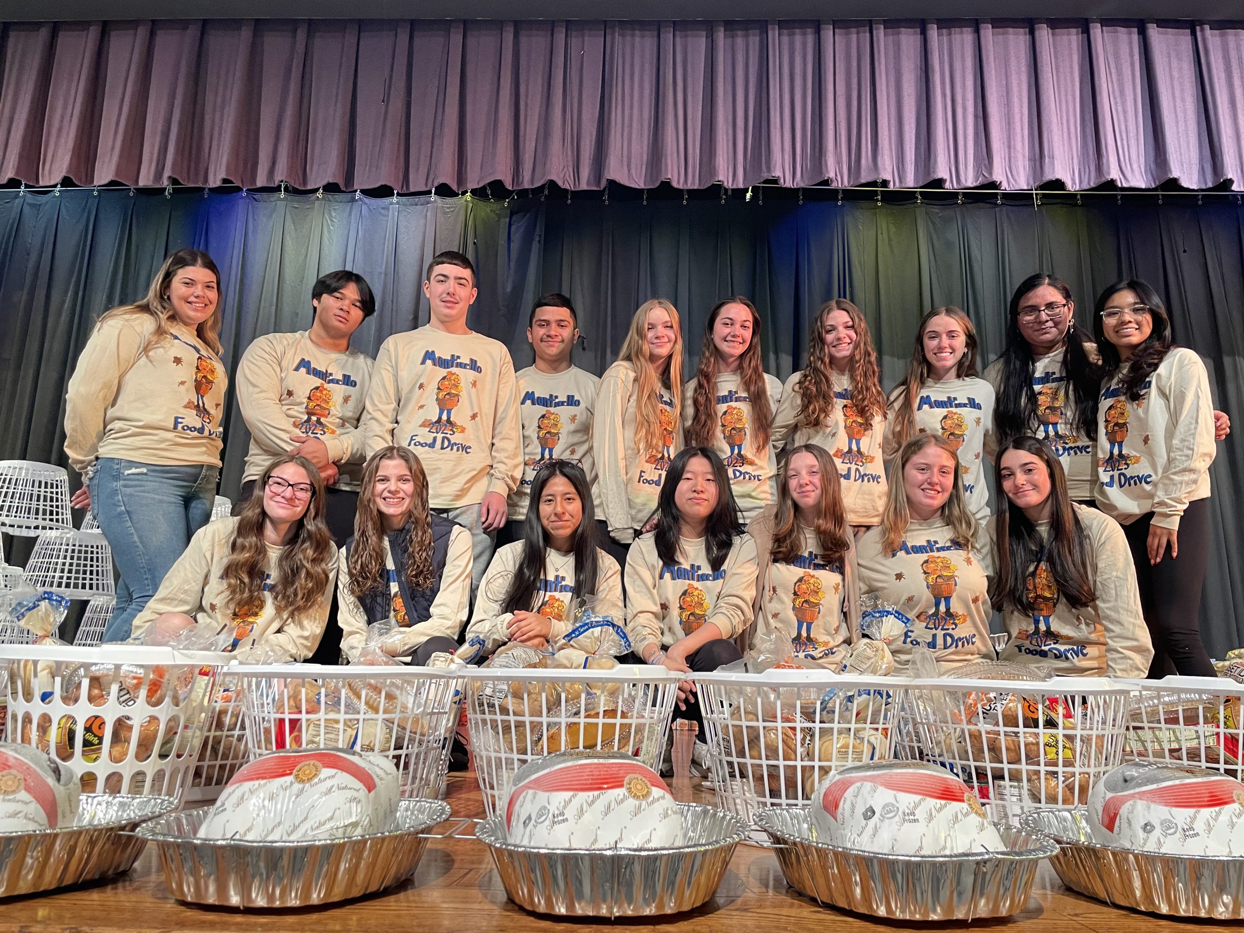 students pose among the food they collected 