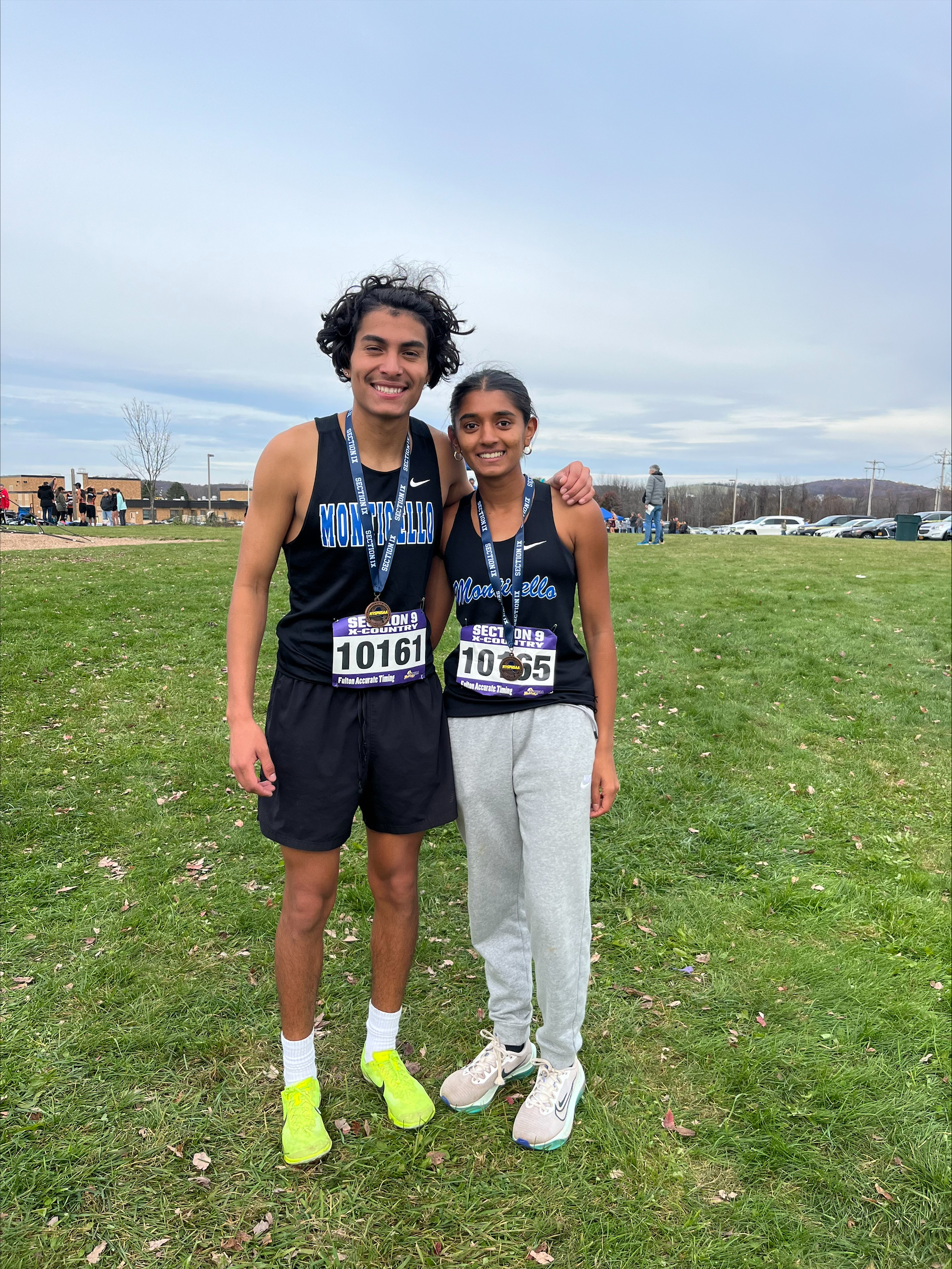 Two track athletes are posing 