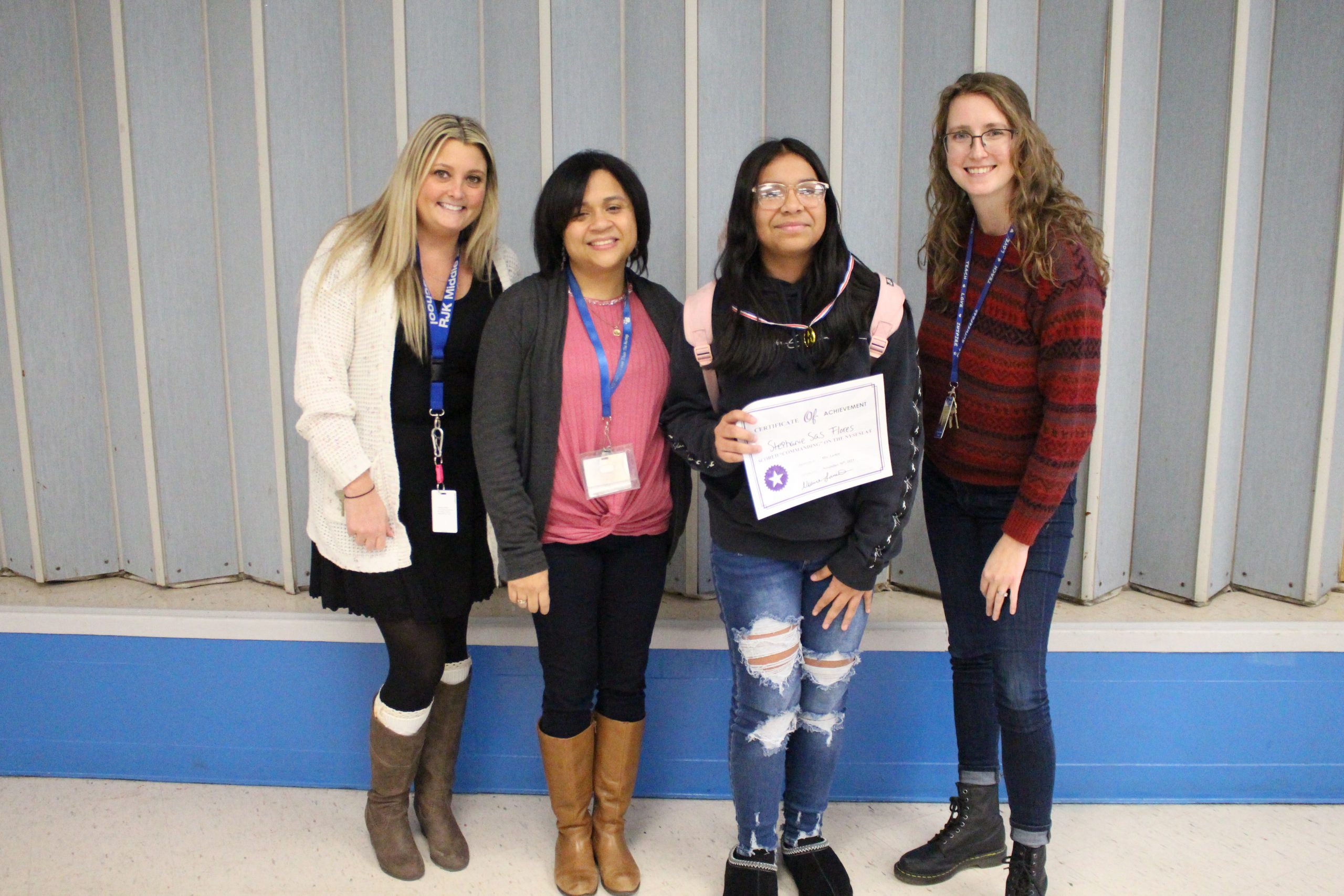 ENL students are posing with their teachers