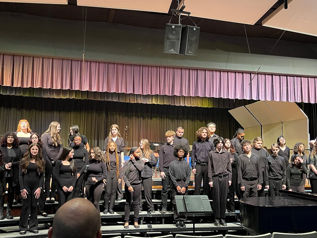 Students singing on stage.