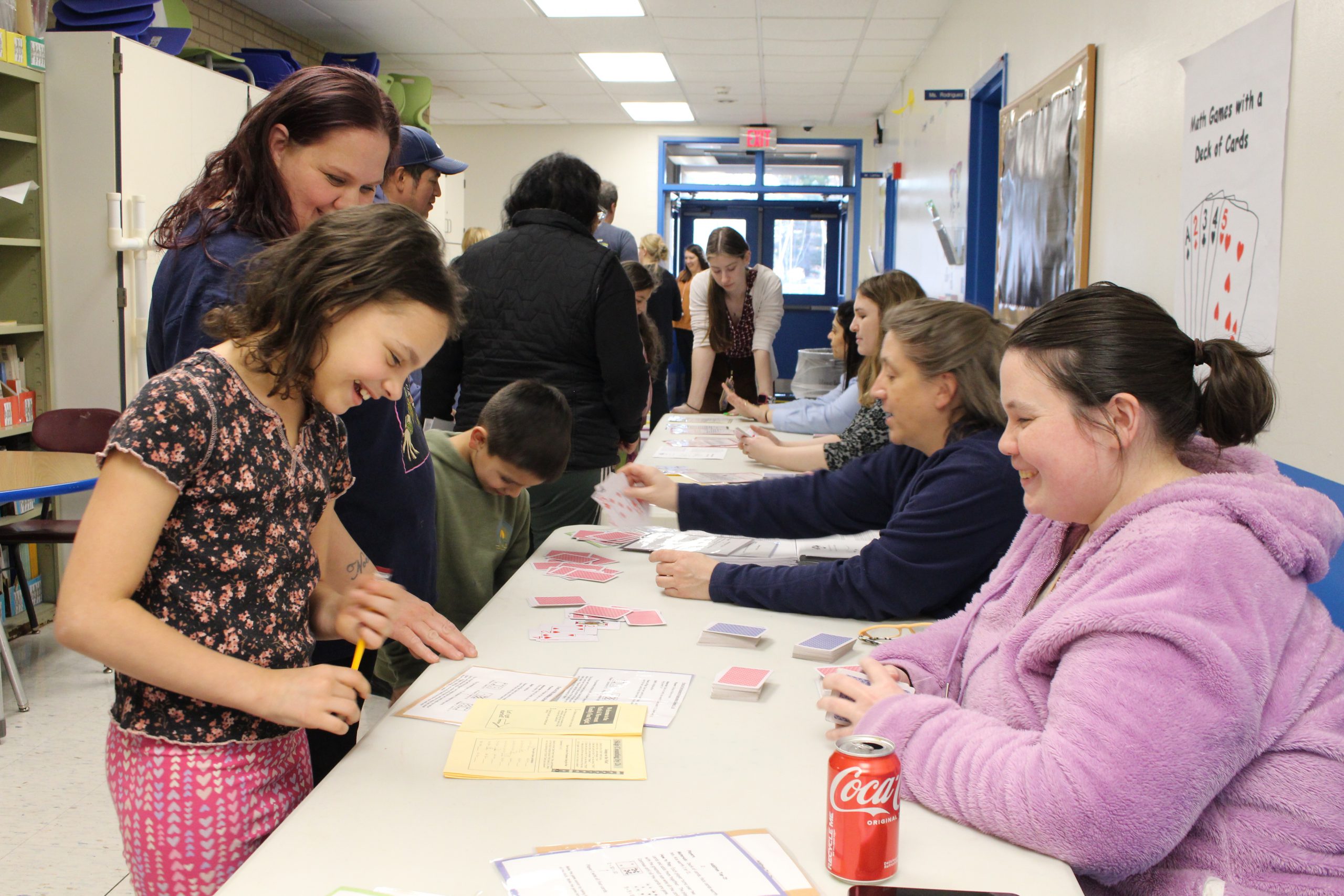 a student and teacher are playing a card game