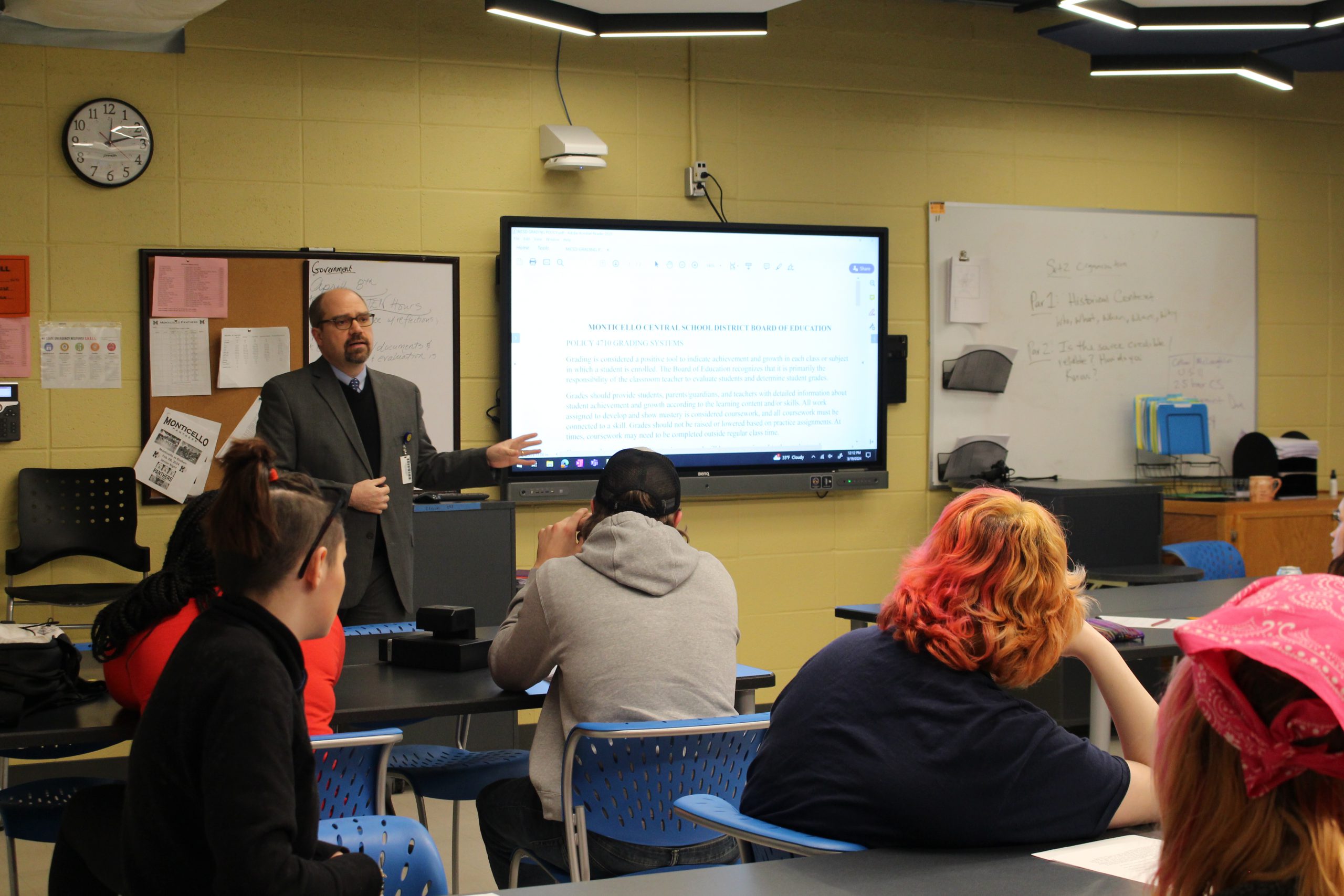 the superintendent is addressing a class full of students. 