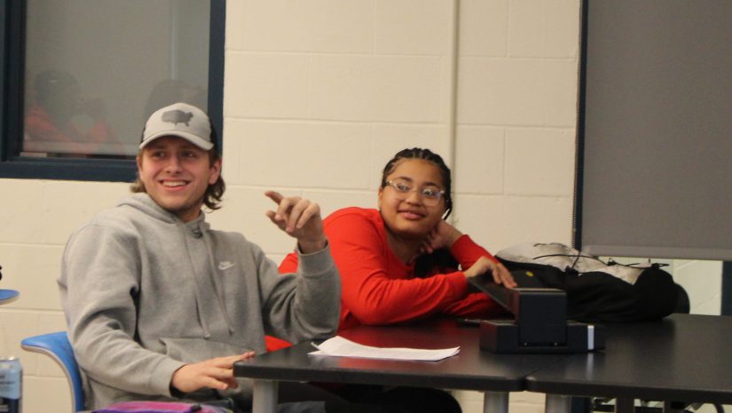 two students are engaged in a discussion.