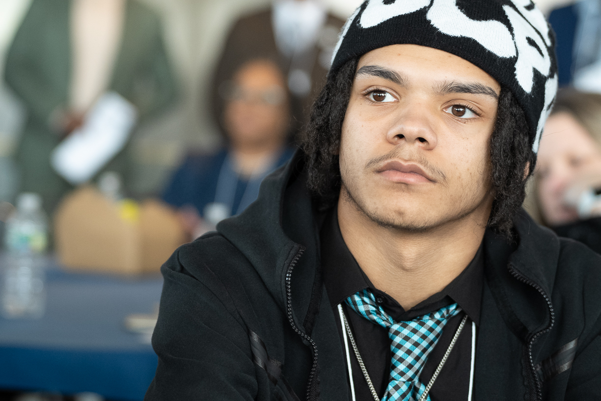 a MBK fellow is watching a speaker intently