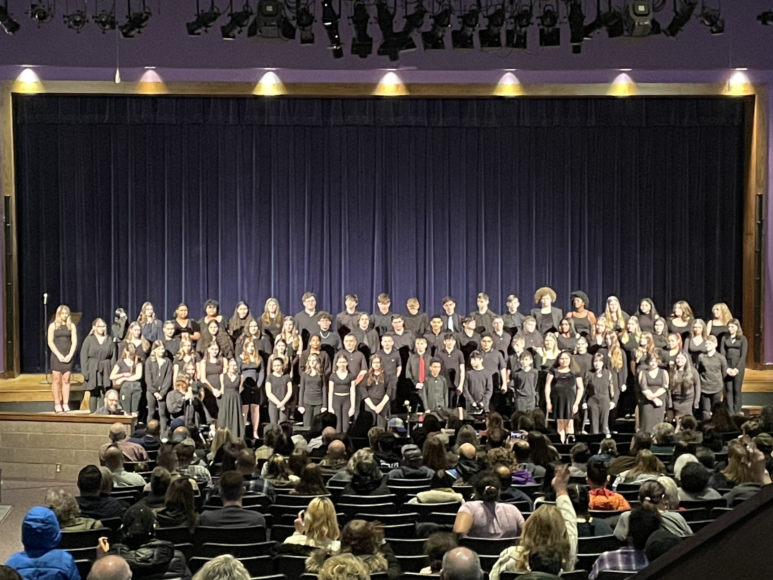 the entire choir is performing on stage