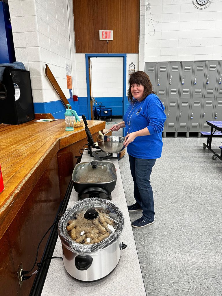 Woman cooking waffles in the auditorium.