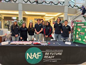 Group photo of Academy of Finance students gift wrap table at mall.